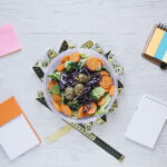 Healthy office snack ideas including fruits, nuts, yogurt, and veggie sticks arranged neatly for work-friendly snacking.